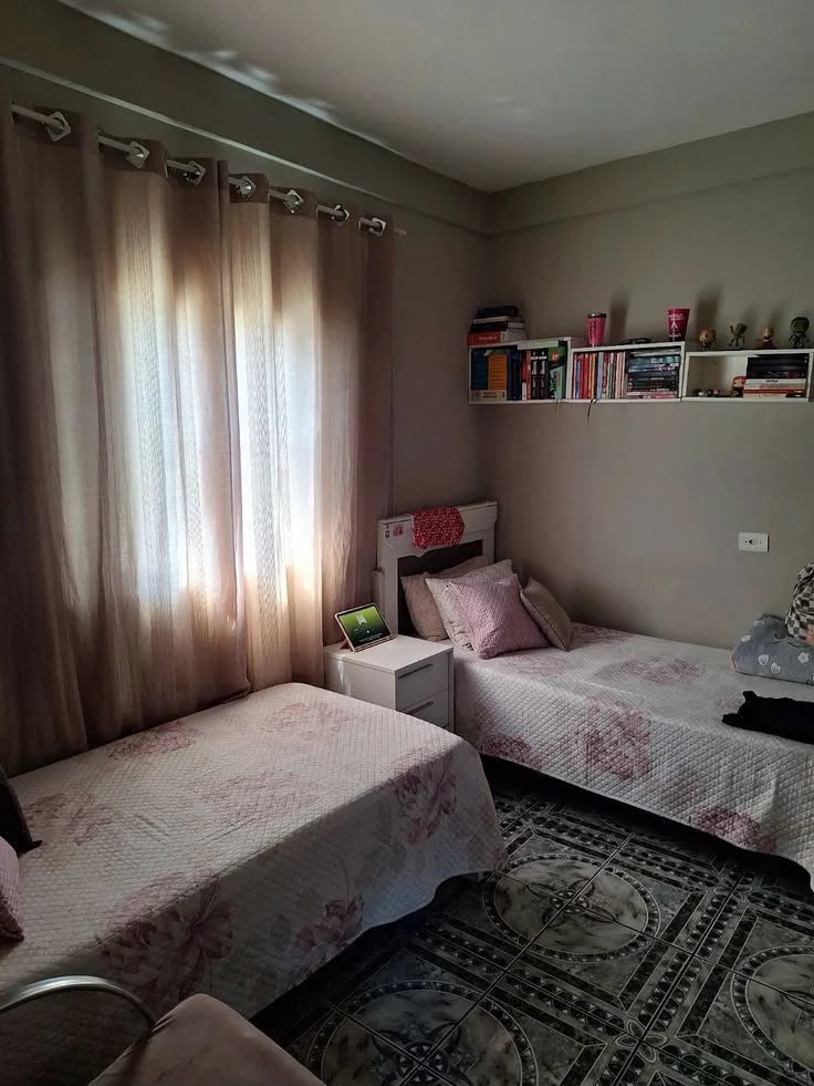 Shared room with soft curtains and bookshelf