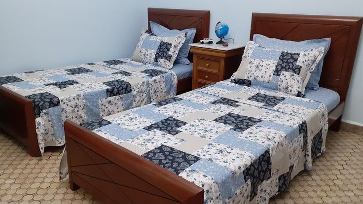 Shared room with patchwork quilts