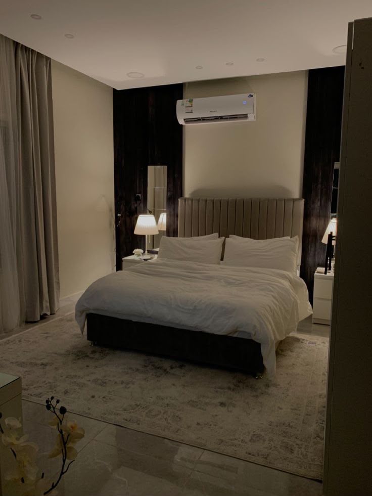 Independent room with plush headboard and warm lighting