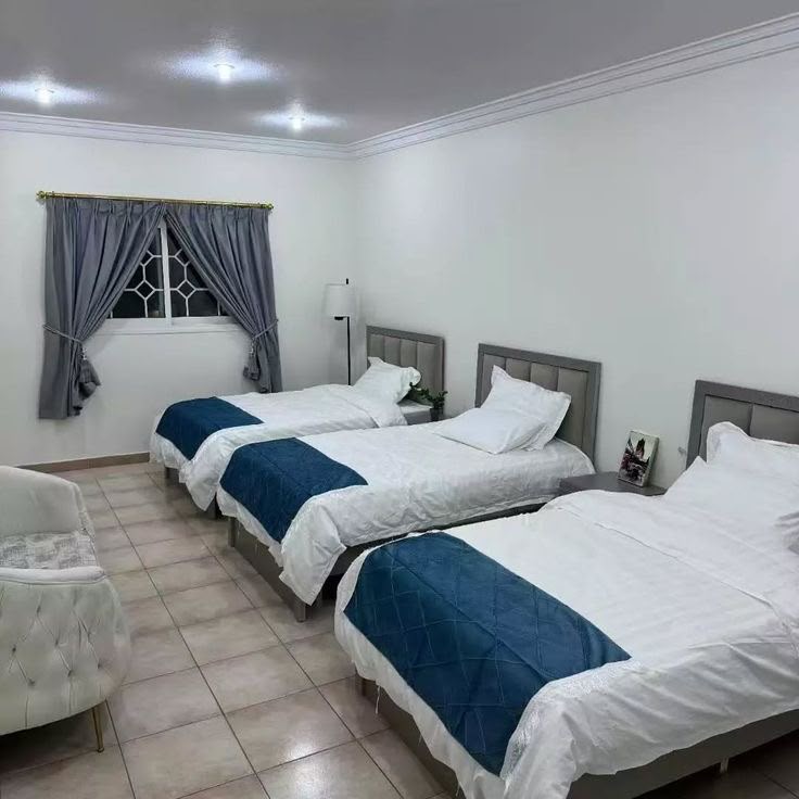 Shared triple room with navy bedspreads